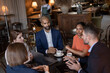 © ReeldealHD images - Group of businesspeople having a meeting in a restaurant