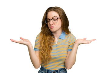 Young caucasian redhead woman isolated confused and doubtful shrugging shoulders to hold a copy space.