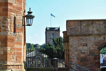 Wall Mural - Church Tower with Flagpole with Foreground Ancient Stone Walls and Lantern 