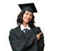 Young university graduate Argentinian woman over isolated background pointing finger to the side