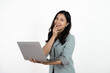 © Parichat - Happy asian business woman holding laptop computer and looking at the camera over white background.