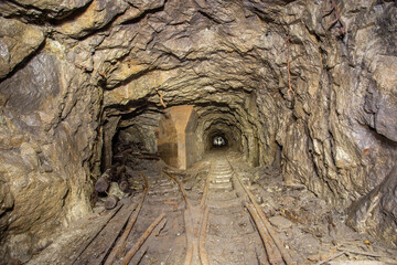 Wall Mural - Underground gold mine shaft tunnel drift with rails