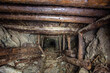 Old gold mine underground tunnel with wooden timbering