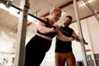 © Flamingo Images - Pregnant woman working out with a trainer