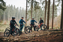 Smiling Friends Out Mountain Biking Together In A Forest