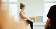 © Flamingo Images - Yoga teacher leading a class in her studio