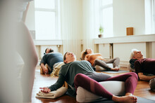 Yoga Students Doing The Reclined Butterfly Pose