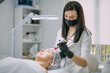 © Anna - Cosmetologist and dermatologist makes injections with a mesotherapy apparatus to a lying woman patient in a beauty salon.