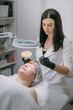 © Anna - Cosmetologist and dermatologist makes a moisturizing, rejuvenating woman lying patient in a beauty salon.