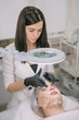 © Anna - Cosmetologist and dermatologist makes a moisturizing, rejuvenating woman lying patient in a beauty salon.