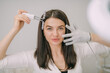 © Anna - Portrait of a young beautiful woman beautician in a medical white uniform in her office with cosmetology equipment