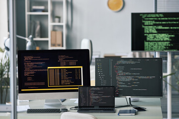 Computers and laptop on office desk, programming and testing concept