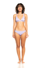 Young Smiling Exotic Brunette Woman In Lilac Bikini Swimsuit Posing On A White Background. Front View.