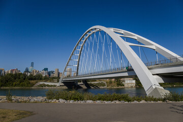 Wall Mural - Modern arc bridge over the river,  day traffic, summer time. modern architecture, panorama of the city Edmonton
