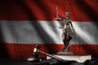 Austria flag with statue of lady justice, constitution and judge hammer on black drapery. Concept of judgement and guilt