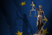 European Union Flag With Statue Of Lady Justice And Judicial Scales In Dark Room. Concept Of Judgement And Punishment