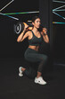 strong asian girl in sportswear lifting bulgarian training bag.Youth strength sport.