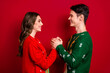 © deagreez - Profile photo of two idyllic peaceful lovers hold arms look each other eyes isolated on red color background