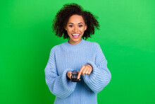 Portrait Of Excited Positive Lady Arms Hold Remote Control Press Power Button Isolated On Green Color Background