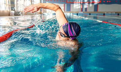 Swimmer in the pool. A male athlete is engaged in swimming in a sports pool.