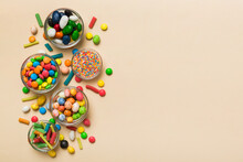 Different Colored Round Candy In Bowl And Jars. Top View Of Large Variety Sweets And Candies With Copy Space