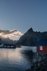 Wall Mural - A sunset sky over Lofoten island in Norway, with a rocky mountain and clouds in the background