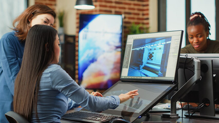 Team of people working with touchscreen display for gaming app development in creative agency. Professional creators using graphics on modern software to develop new interface plan.