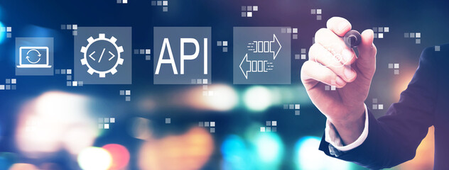API - application programming interface concept with businessman on night city background