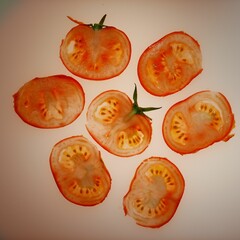 Wall Mural - Flat lay of tomato slices on an off-white background