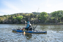 Man Paddling And Kayak Fishing On Possum Kingdom Lake