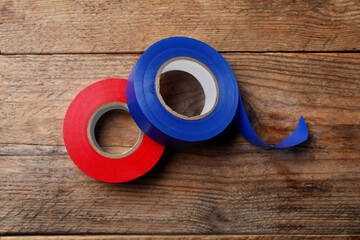 Canvas Print - Colorful insulating tapes on wooden table, top view