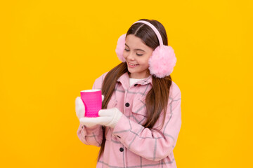 Poster - happy kid in fur earmuffs. female fashion model on yellow background.