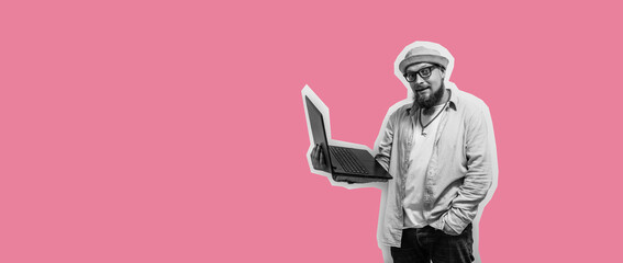 Young crazy bearded charismatic man. Shocked or surprised expression. Laptop concept. Funny promotion poster. Programmer, web developer holding a laptop in his hands and looking at the camera
