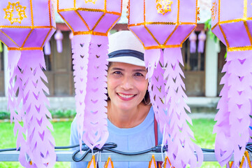 Poster - Asian female tourist while touring the Lanna style festival in Lamphun province