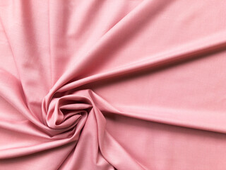 Soft silk textile texture for background. Abstract pink fabric for poster, banner, wallpaper and creative project.