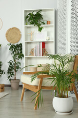 Wall Mural - Stylish room interior with comfortable armchair and beautiful houseplants