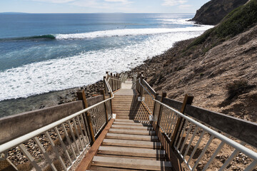 Newly improved staircase leading down to remote Dume Cove beach surf area in Malibu, California.