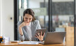 © David - Happy Asian Business woman using calculator and laptop for doing math finance on an office desk, tax, report, accounting, statistics, and analytical research concept