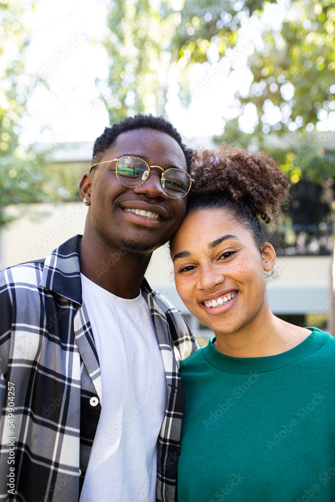 Vertical portrait of happy African American young couple outdoors ...