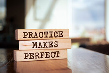Wooden Blocks With Words 'Practice Makes Perfect'.