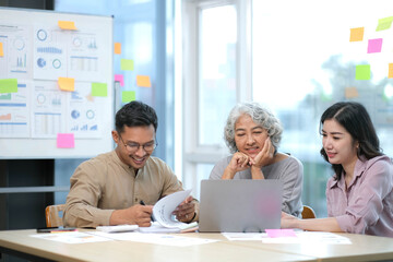 Business team analyzing income charts and graphs ,Financial Analysis with modern laptop computer. Close up.Business analysis and strategy concept