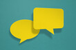 © Ratana21 - yellow and pink speech bubble grunge paper cut on grunge green background. Conceptual image about communication and social media, customer feedback