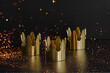 Leinwandbild Motiv Epiphany  Day or Dia de Reyes Magos concept. Three gold crowns on black background with golden particles.