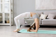 © Kanstantsinzzz - Young athletic woman practices yoga in the studio. yoga class. High quality photo