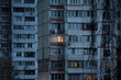Light in one window in apartment multistorey building during the rolling blackout of electricity in a residential area of Kyiv after russian shelling of power plants.