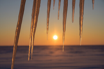Wall Mural - vessels on the background of a frozen lake. sunset in winter.