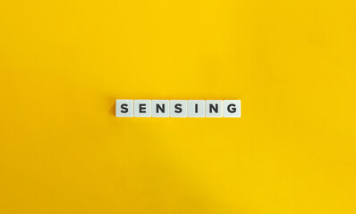 Wall Mural - Sensing Word and Banner. Letter Tiles on Yellow Background. Minimal Aesthetics.