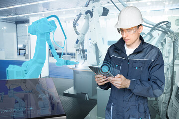 Fototapete - Engineer uses a digital tablet to control robots in a smart factory. Smart industry 4.0 concept