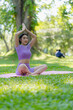 © ArLawKa - Fitness woman doing yoga in park, calm and relaxing women's happiness blurry background Asian woman meditating while practicing yoga concept of freedom peace and relaxation healthy