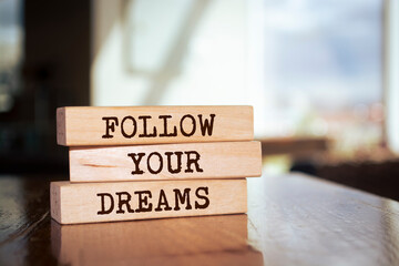 Poster - Wooden blocks with words 'Follow Your Dreams'.